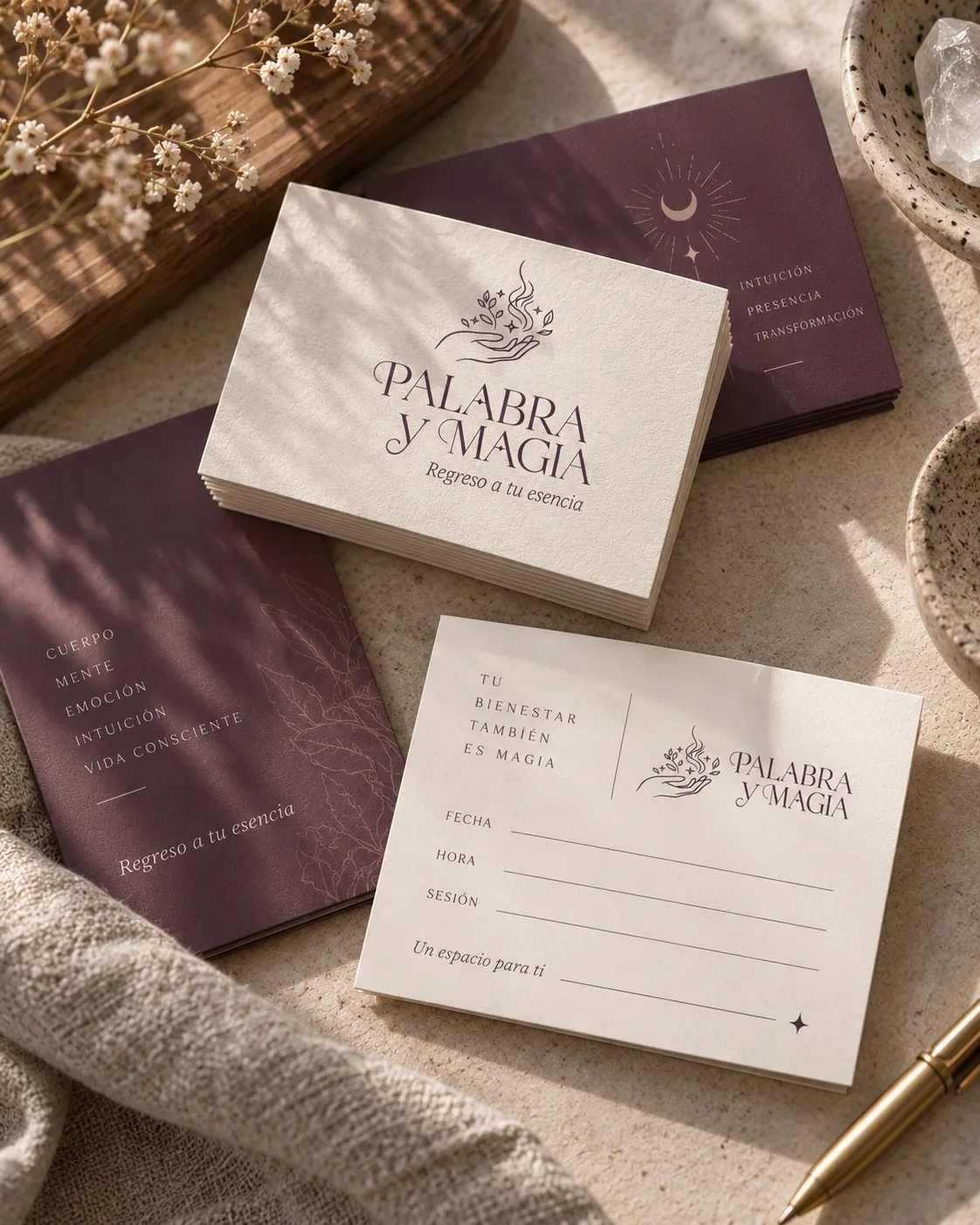 Palabra y Magia stationery in mauve and sand on a wooden table
